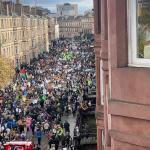 People at a climate protest carrying Palestinian flags-photo