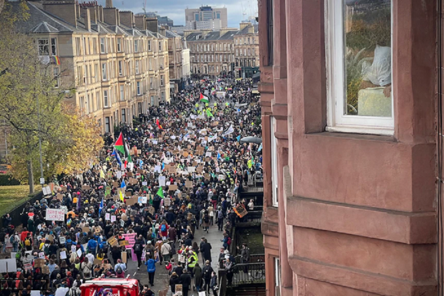 People at a climate protest carrying Palestinian flags-photo